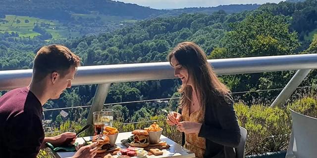 H of A Couple eating with view